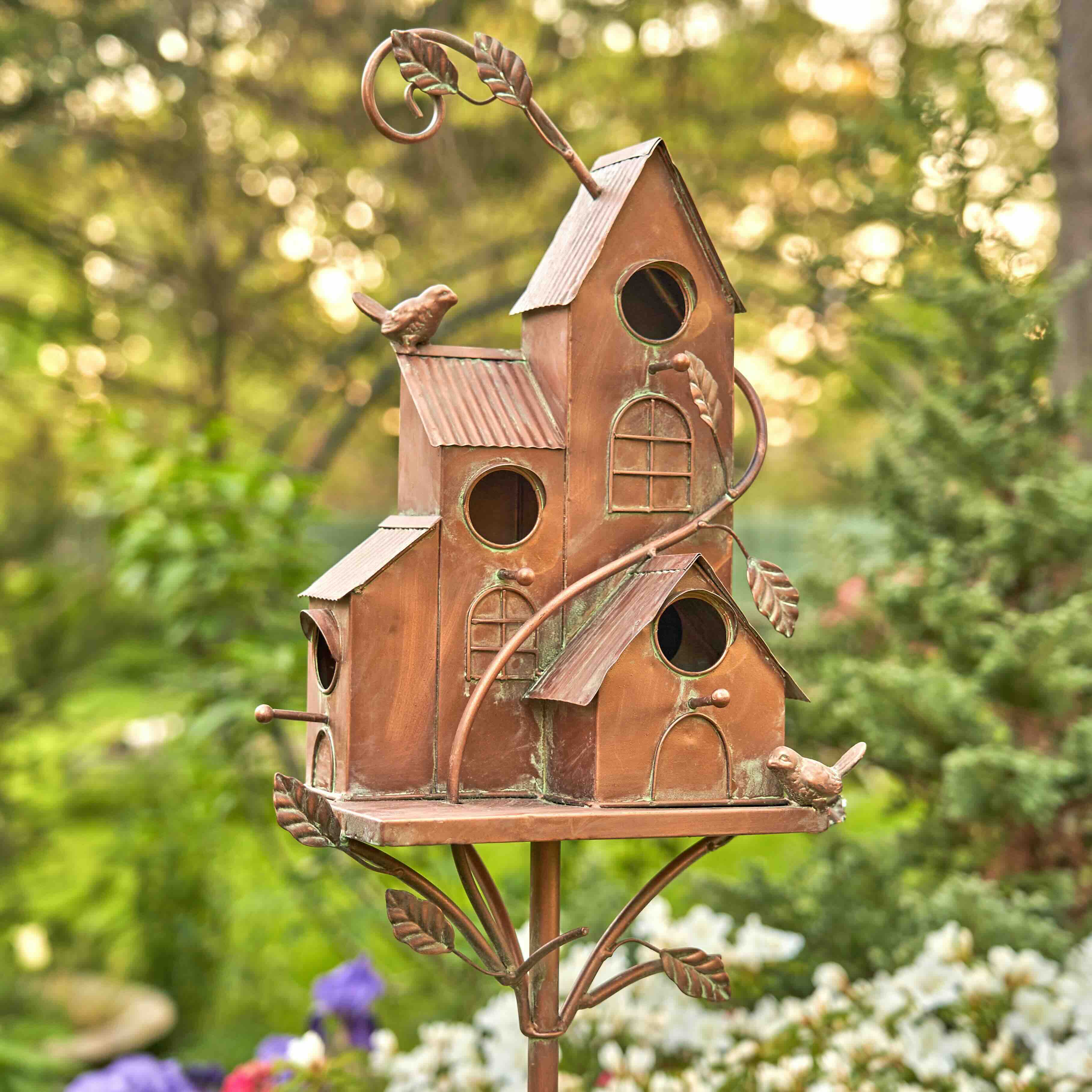 Philadelphia Favorite Copper Color Birdhouse Garden Stake Decoration Photoed in a Beautiful Garden Full of Lush Vegetation. The best birdhouse for birds and a lovely piece to look at. The top selling design on the market at the best price available. ZR193144